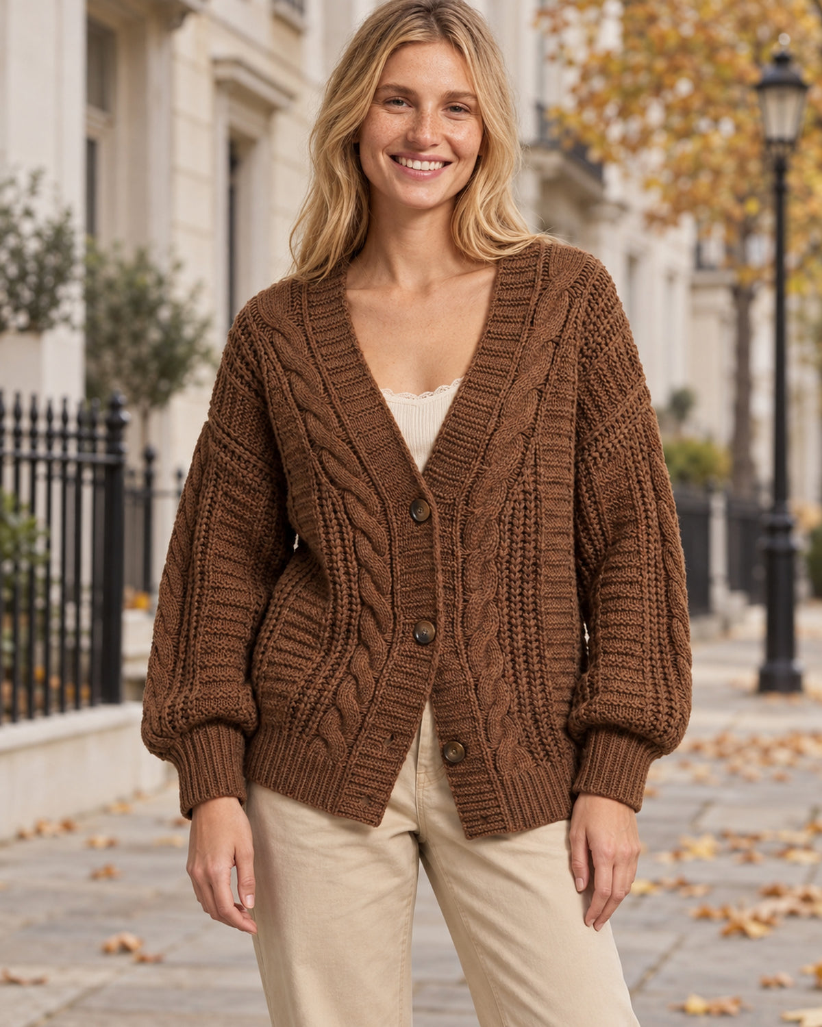 Women's Cable Knit V-Neck Cardigan in Coffee Brown styled on a London autumn street