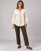 Women's Long Sleeve Shirt in Apricot on a neutral background