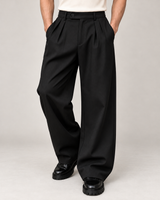 Men's wide-leg pleated trousers in black on a neutral background