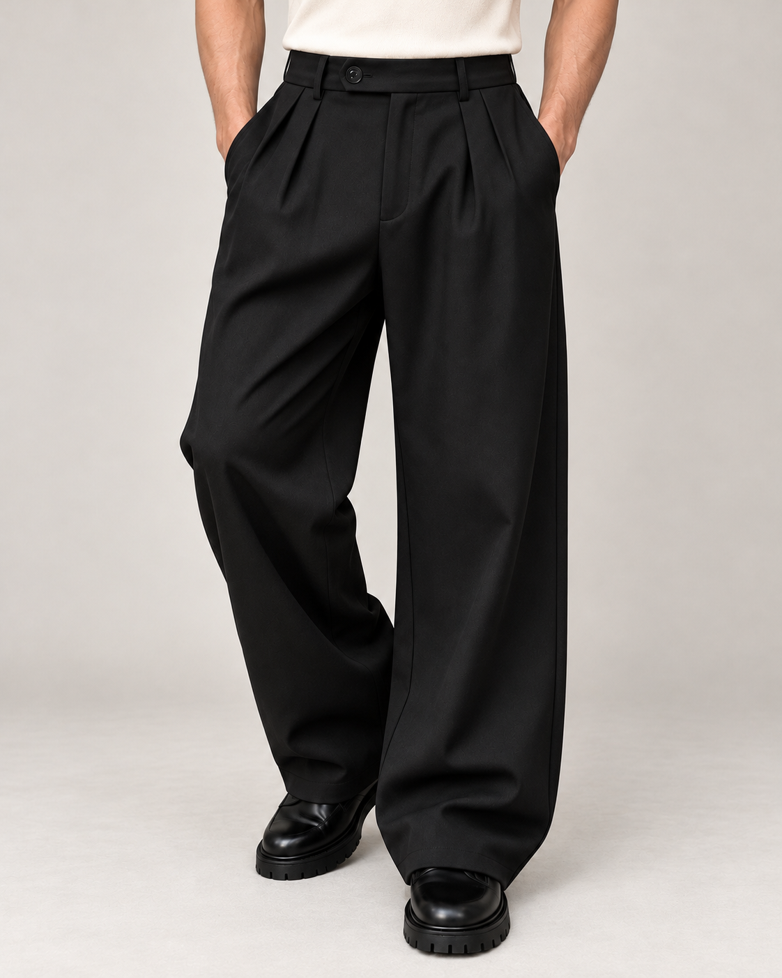Men's wide-leg pleated trousers in black on a neutral background
